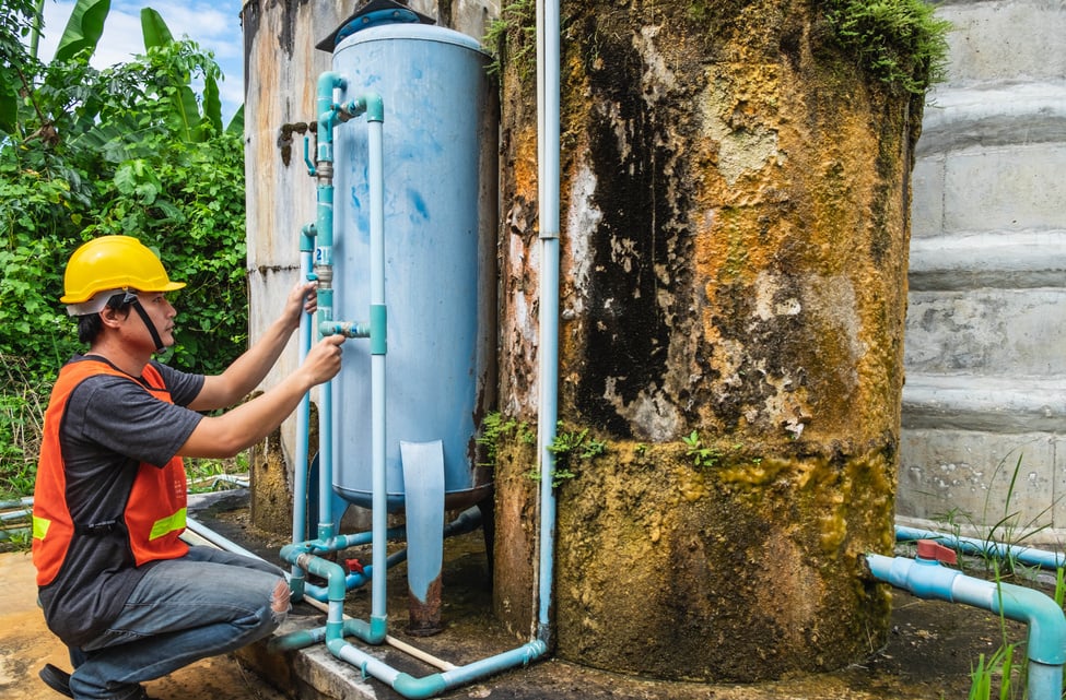 Plumber Repairing Water Tank and Water Filter.